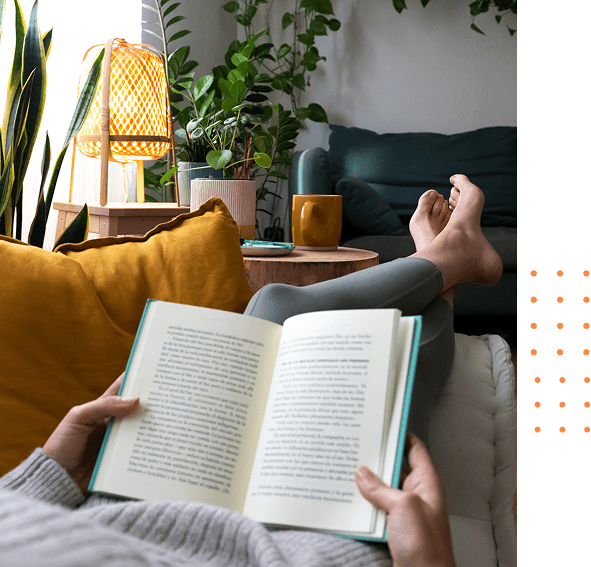 Reading a book on cozy couch